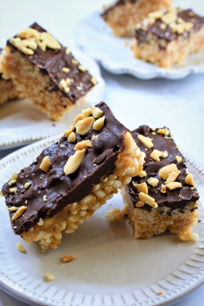 vegan rice krispie treats with peanut butter and chocolate on small vintage dessert plates
