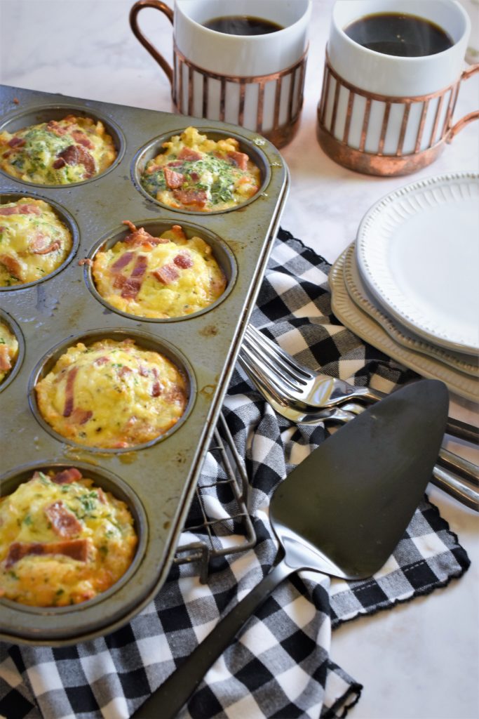 Mini Bacon and Egg Tater Tot Casseroles in muffin pan with black and white check napkin ready for a brunch party 
