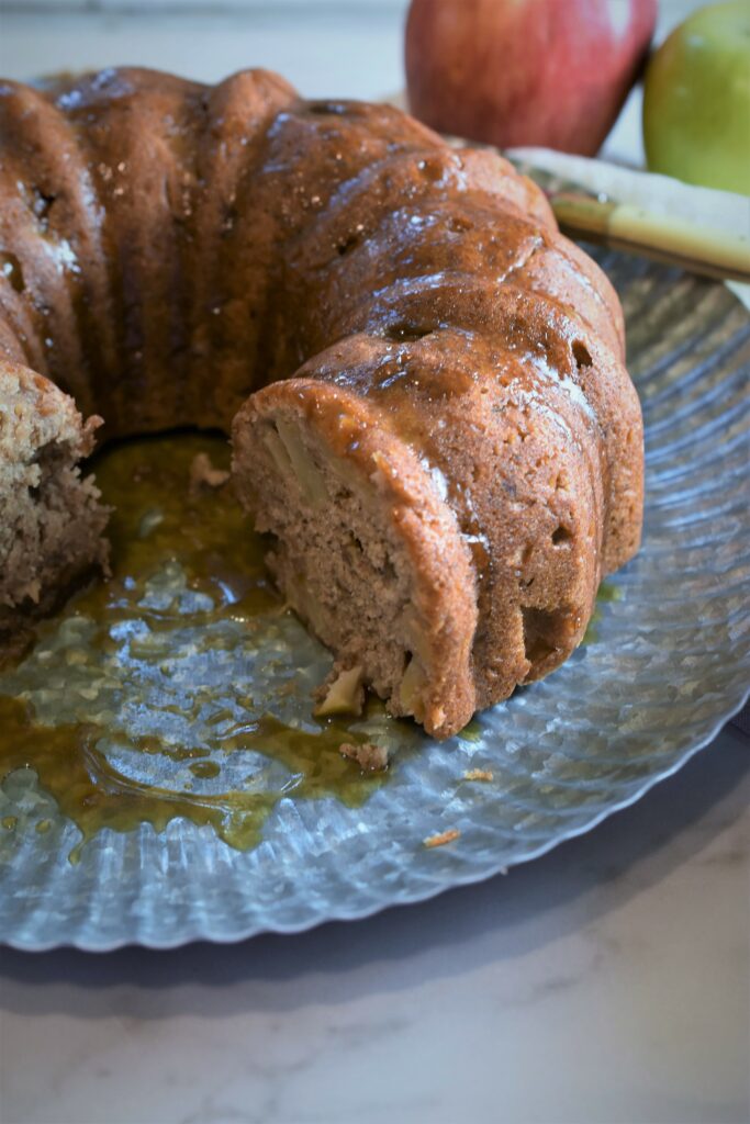 yummy baked cake on tray with slices removed 