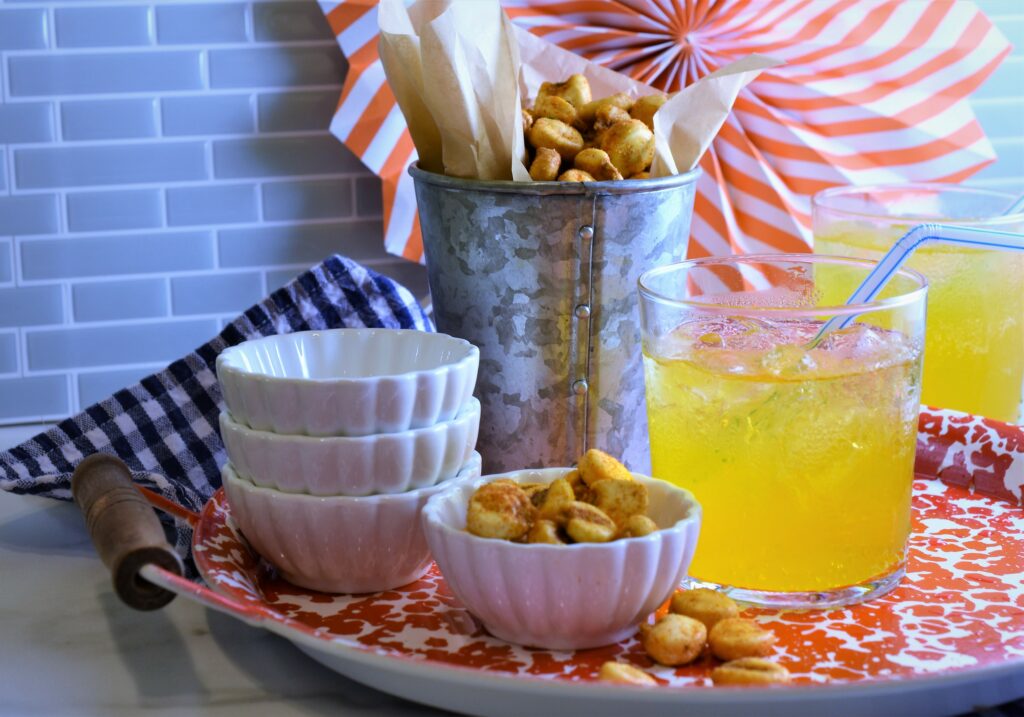 BBQ corn nuts on red and white serving tray with soda