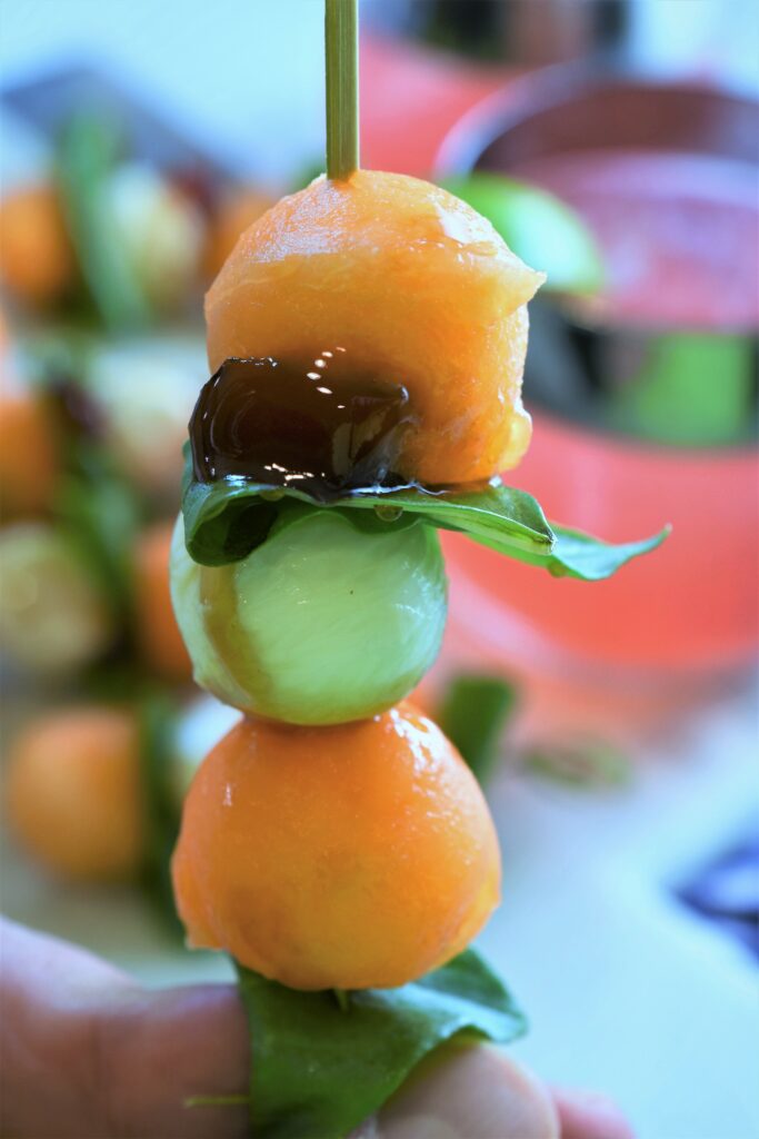 image of hand holding one skewer appetizer 