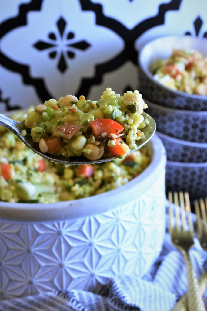 large serving spoon of vegetables and grains