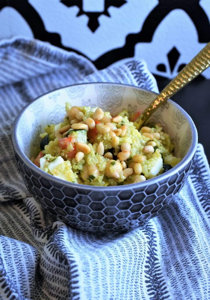 individual bowl of quinoa salad with pine nuts