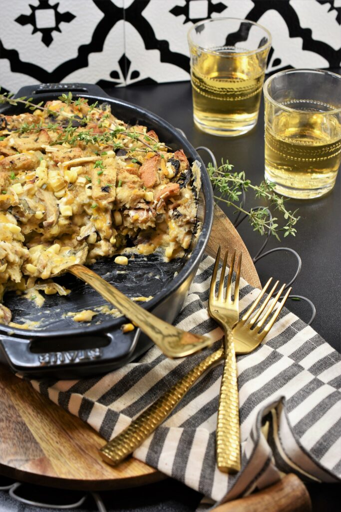 black oval with half served dinner with glasses of wine next to it