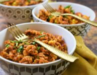 vegan chorizo Mexican goulash in 3 modern gold and white bowls with gold forks