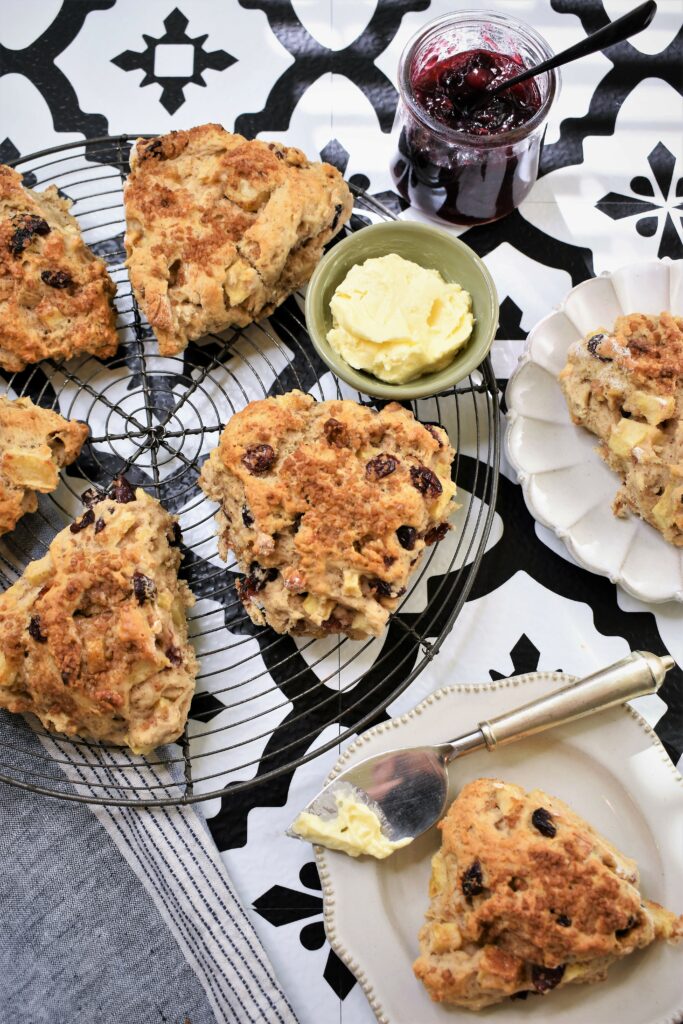 brunch scones on vintage round cooling rack with plates of scones scattered around with butter and jam