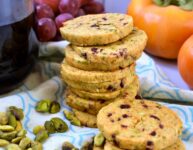 cranberry pistachio shortbread crackers stacked high with a glass of red wine