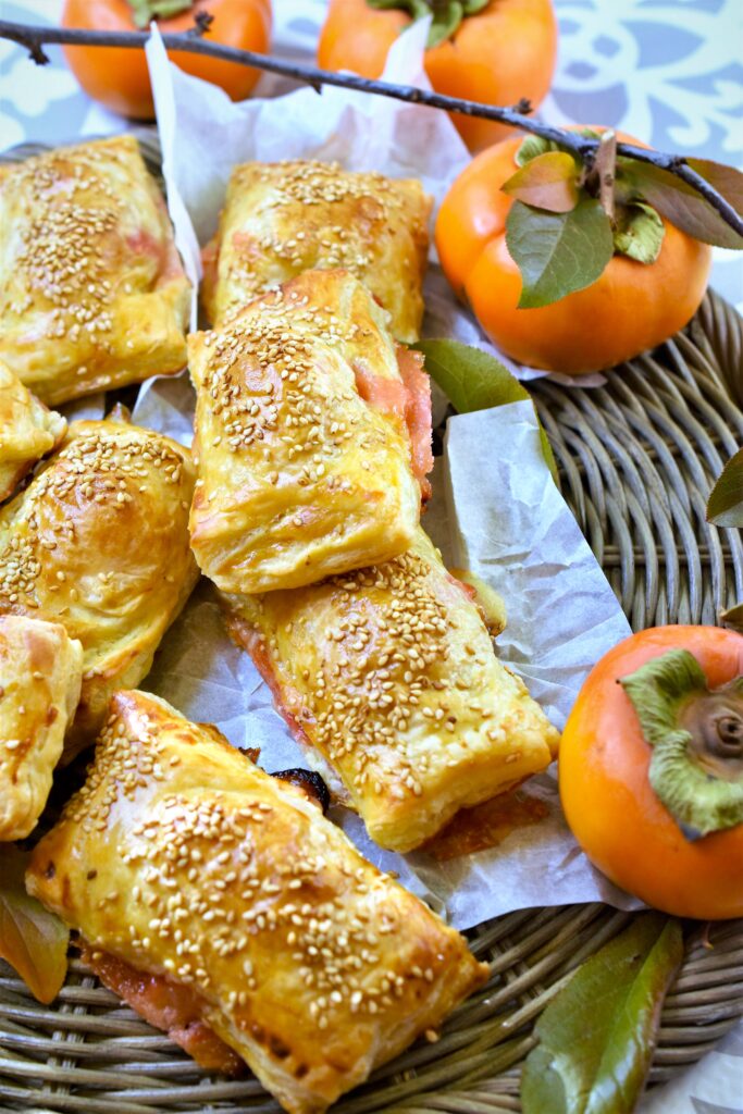 sesame pastry filled with ham and persimmons on wicker charger