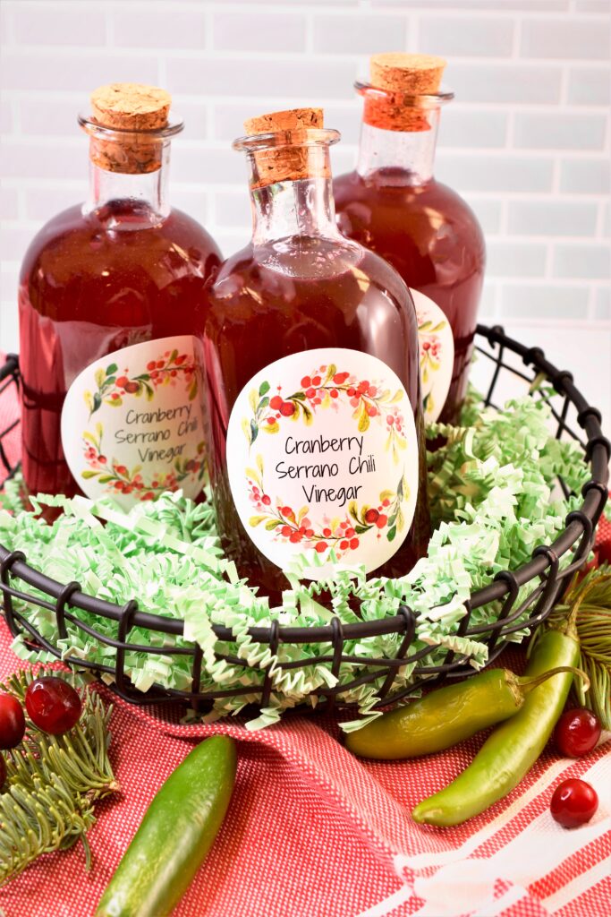cranberry vinegar in corked bottles in black metal gift basket