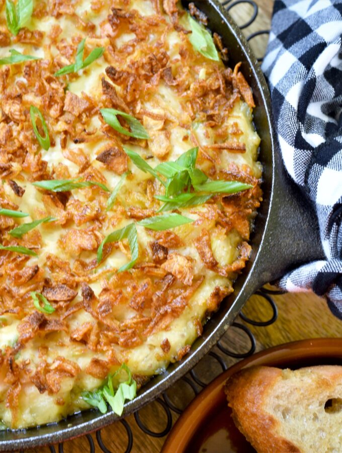 baked triple onion dip vegan and delicious in black cast iron pan with toasts